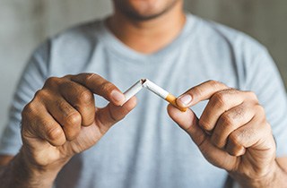 Quit bad habits like smoking to protect your dental implants