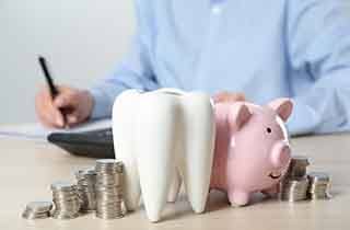 Coins next to a piggy bank