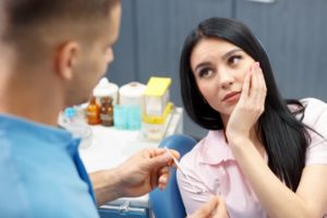 A dentist talking to their concerned patient.