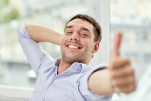 smiling man giving thumbs up