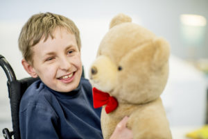 smiling child and teddy bear