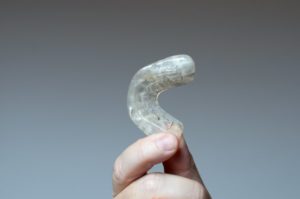 A person holding a mouthguard.