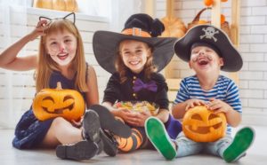 A group of children dressed in Halloween costumes.