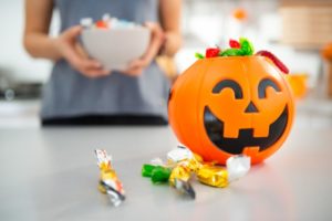 A Jack-o-Lantern bucket sitting on a table.