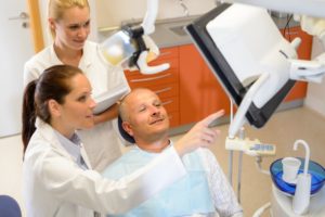 dentist showing their patient an X-ray