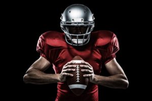 football player holding a helmet