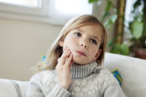 little girl with mouth pain