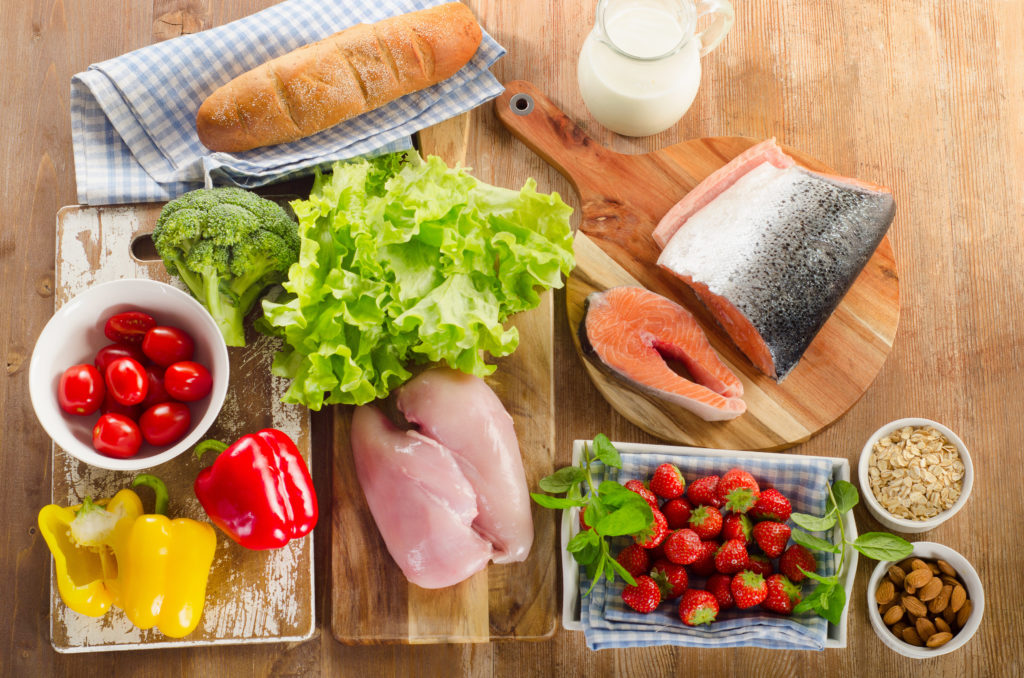 Smile-friendly foods like fish, broccoli, milk, and more on a table