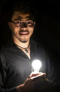 Dr. Henry holding light bulb