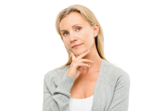 woman with finger on chin thinking