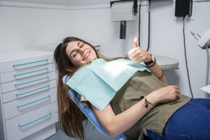 Woman sitting in dentist chair smiling