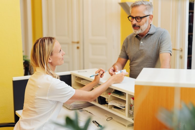 Patient paying receptionist