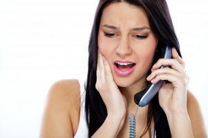 woman calling emergency dentist in Love Field