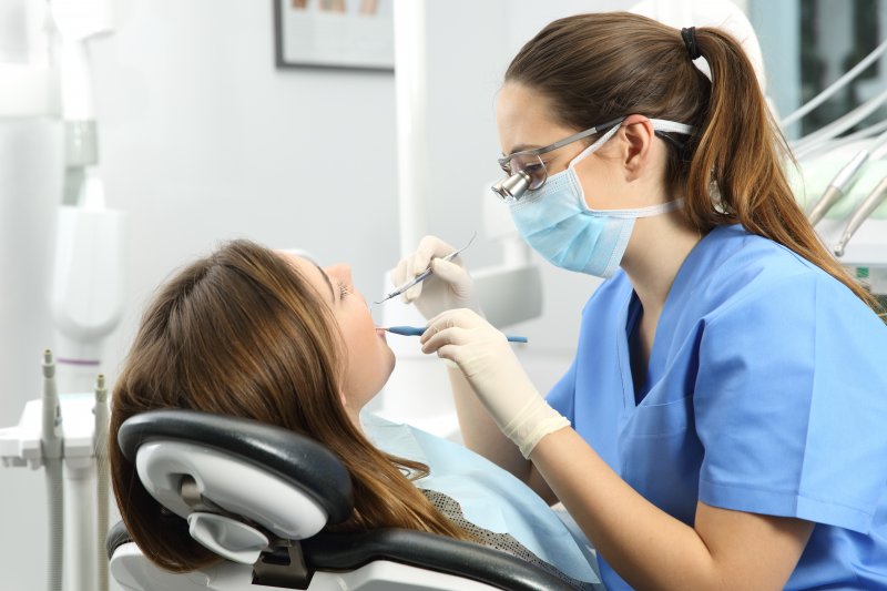 Dental hygienist cleaning patient’s teeth