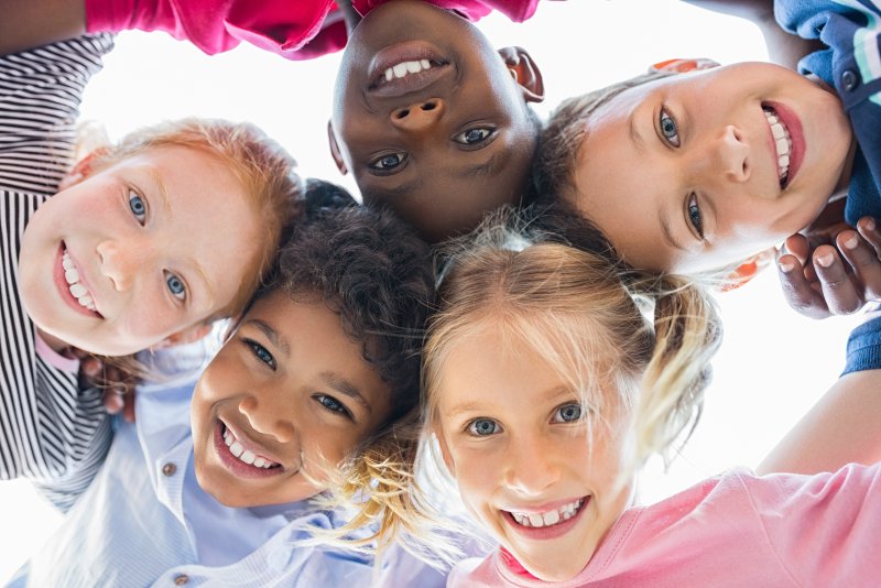 children smiling in circle oral health