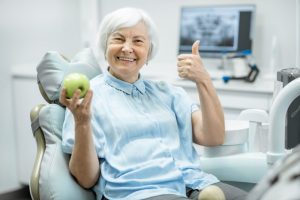 older woman visits dentist in North Dallas