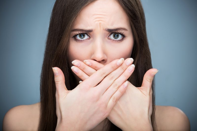 Woman covering her mouth