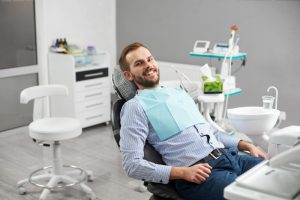 man sitting happily in dental chair 