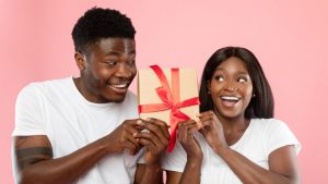 happy couple exchanging Valentine’s Day gifts