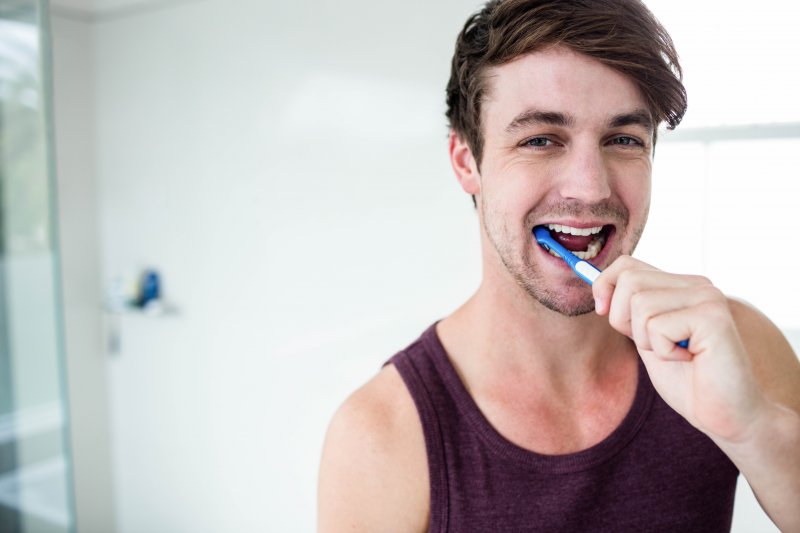 man brushing his teeth in Duncanville