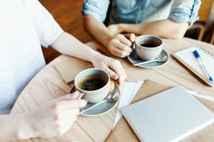 people drinking cups of coffee