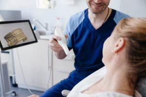 a dental assistant happily helping a patient