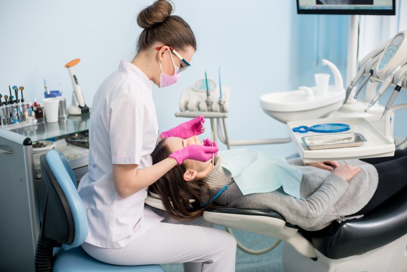 a dental hygienist helping a patient in Love Field
