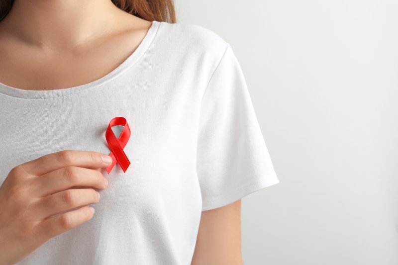 a person holding an oral cancer awareness ribbon 
