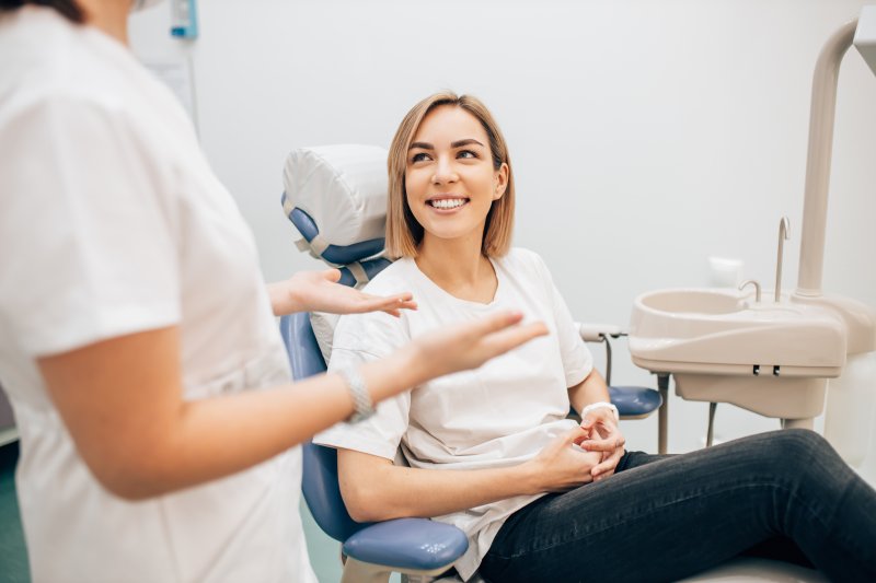 woman smiling while talking to dentist