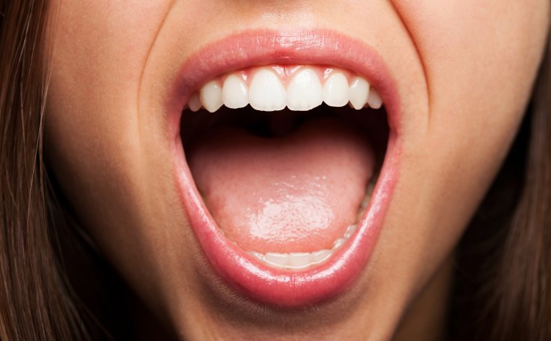 A closeup of a woman's open mouth