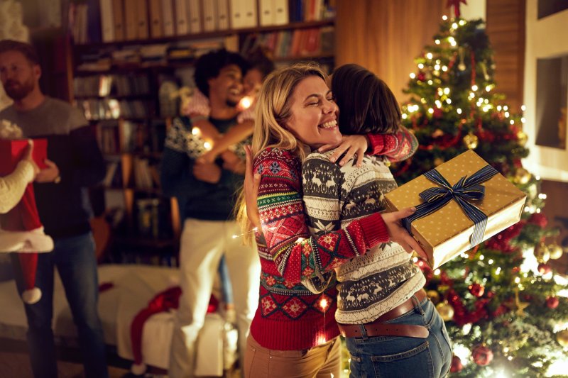 Friends meeting up for the holidays after traveling with good oral health