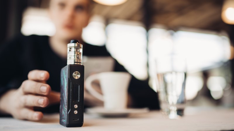 Man reaching for vape despite oral health risks