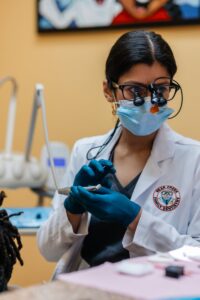 Dentist getting ready to clean her patient's dentures