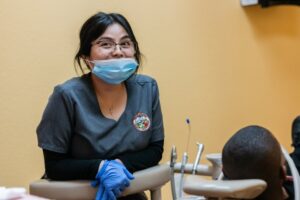 Dental assistant getting her patient ready for root canal