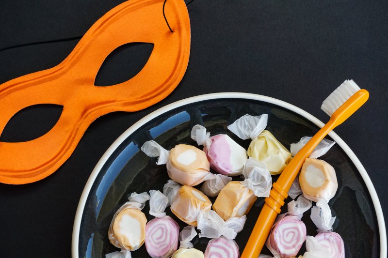 Colorful Halloween sweets with a mask and toothbrush