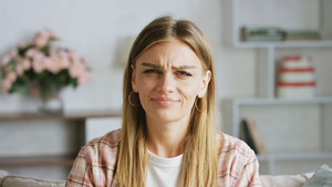 Young woman looking unhappy due to bitter taste
