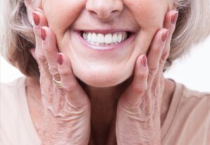 Senior woman smiling with dentures.