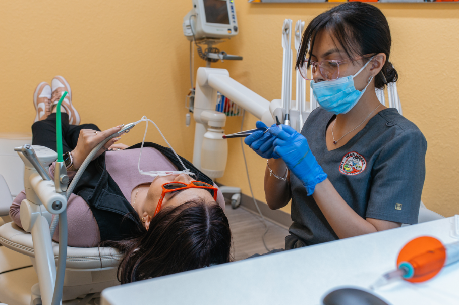 Dental assistant with patient in chair