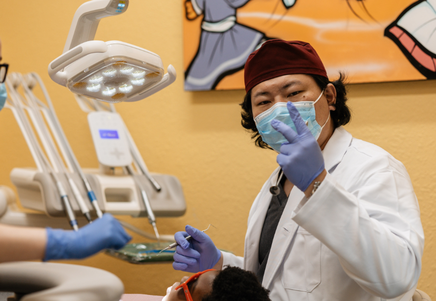 Dentist giving peace sign