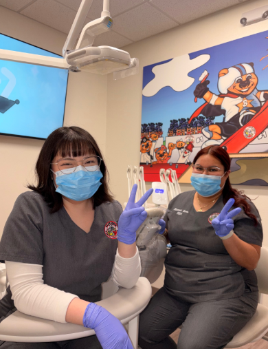 Dental assistants giving peace signs